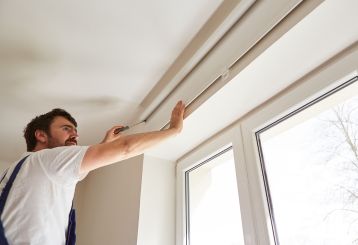 Cordless Roman Shades adorning a window with soft fabric folds.