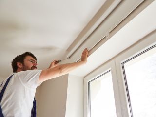 Cordless Roman Shades adorning a window with soft fabric folds.